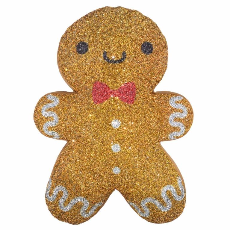 Gingerbread man-shaped pillow in golden-brown with rhinestones red bow and white icing details on a textured surface.
