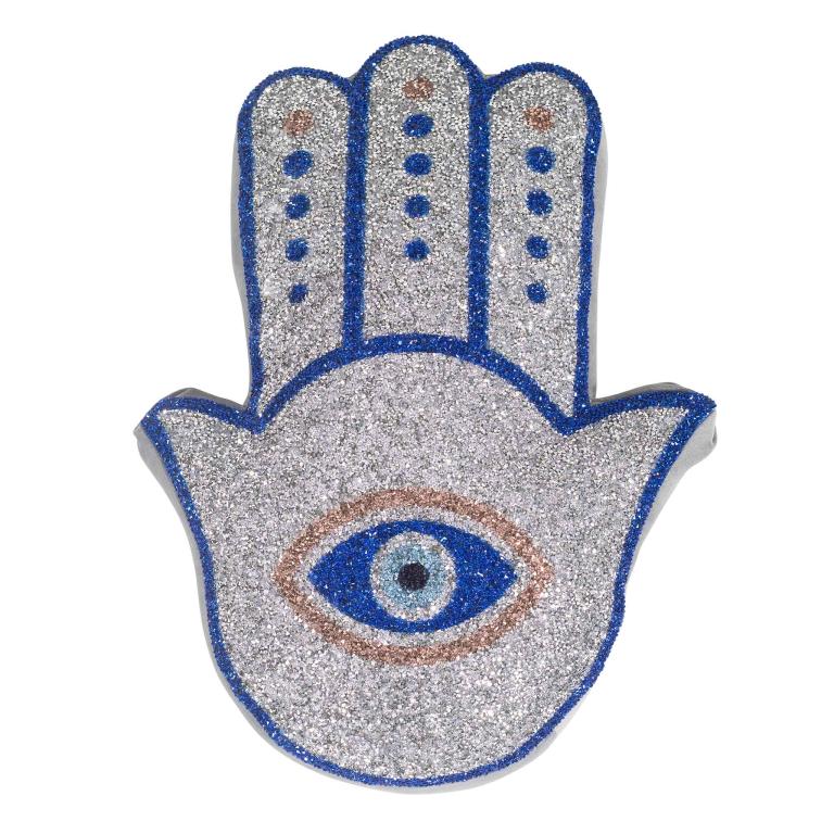 Hamsa-shaped pillow with silver glitter blue trim and an eye design in blue brown and black embellishments.
