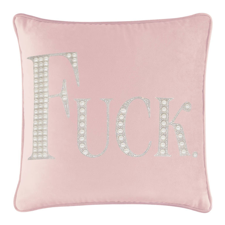 Blush velvet pillow with large rhinestone and faux pearl lettering spelling "FUCK" in silver embellishments.