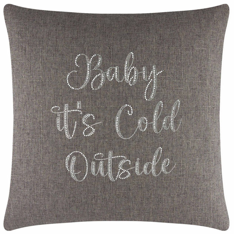 Square brown pillow with a textured fabric and silver glass rhinestones forming the phrase "Baby it's Cold Outside".