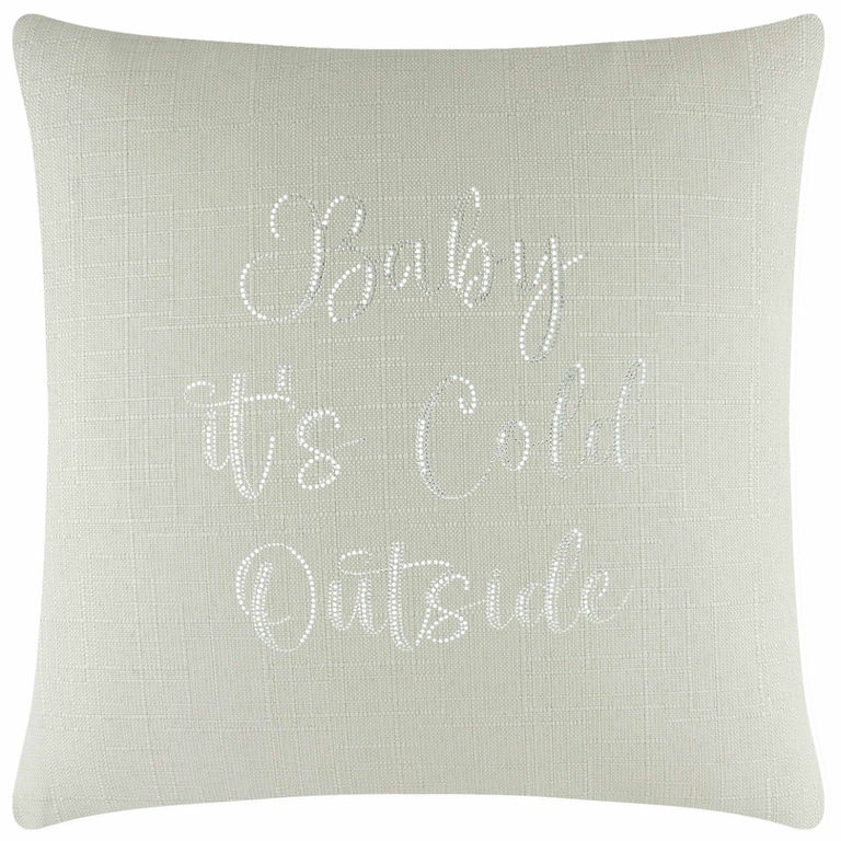 Square light green linen pillow with glass rhinestones spelling "Baby it's Cold Outside" in cursive font.