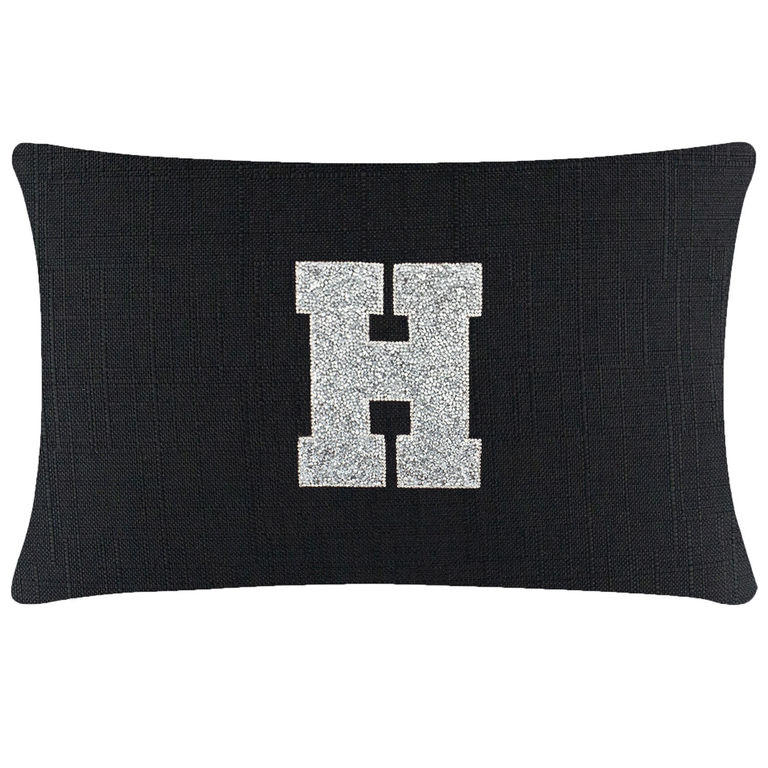 Black rectangular pillow featuring a textured fabric and a glittering silver rhinestone letter "H" in the center.