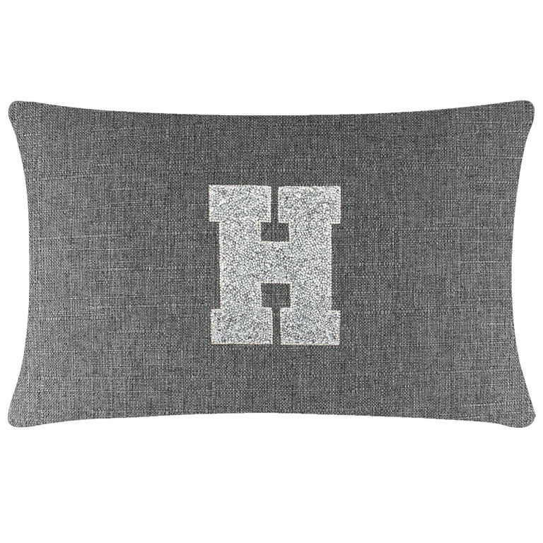Gray rectangular pillow with a textured fabric featuring a large silver rhinestone letter "H" in the center.