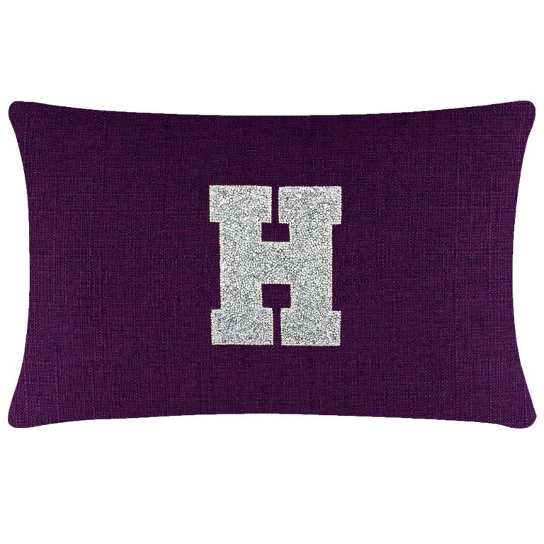 Purple rectangular pillow featuring a textured fabric and a large silver rhinestone monogram "H" in the center.