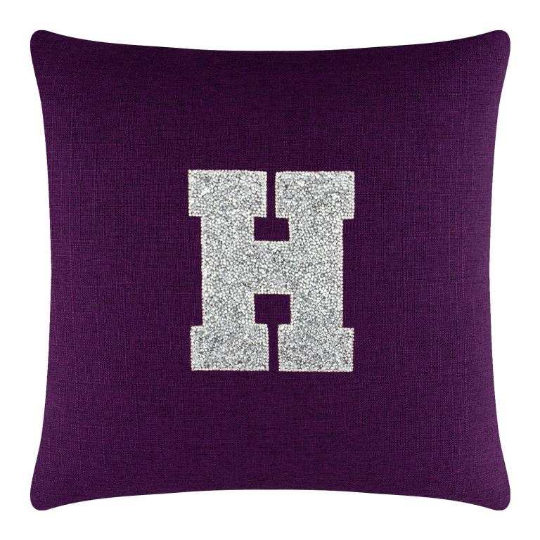 Purple linen pillow featuring a large silver rhinestone monogram letter "H" in the center.