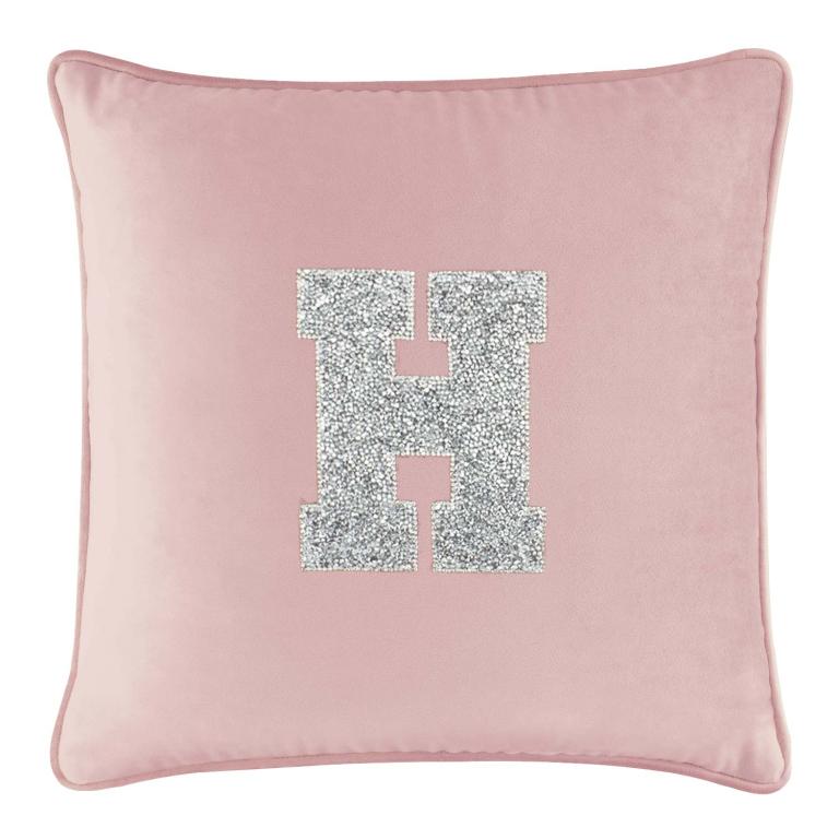 Pink velvet pillow with a large silver rhinestone letter "H" in the center and a piped edge.