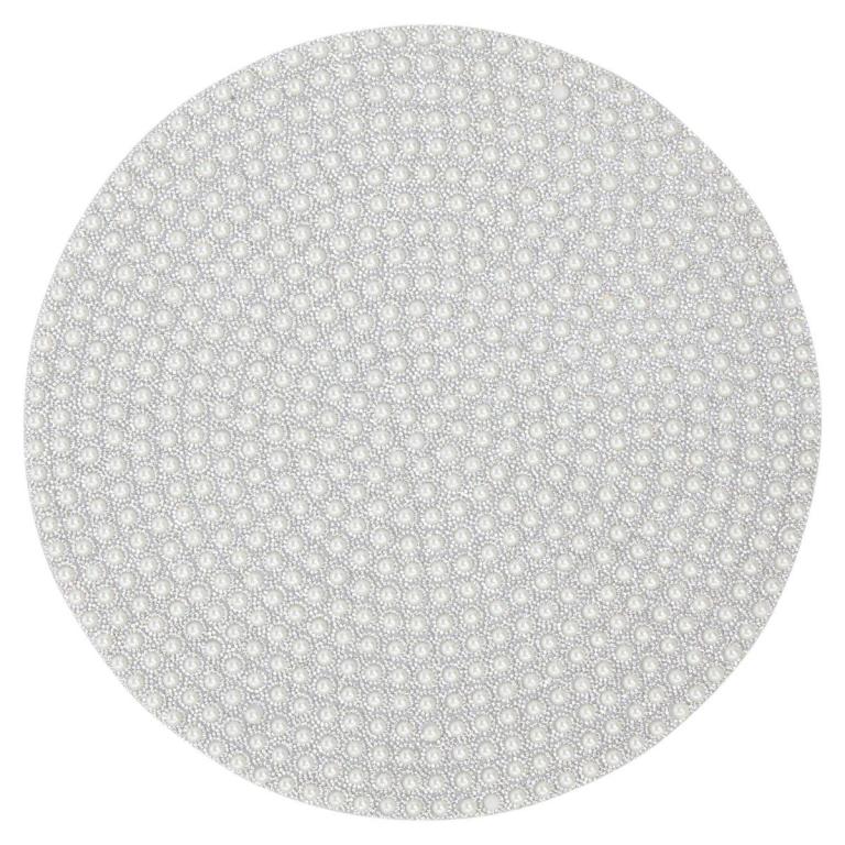 Round placemat featuring a pearl-like texture with sparkling rhinestones set against a soft gray background felt backing.
