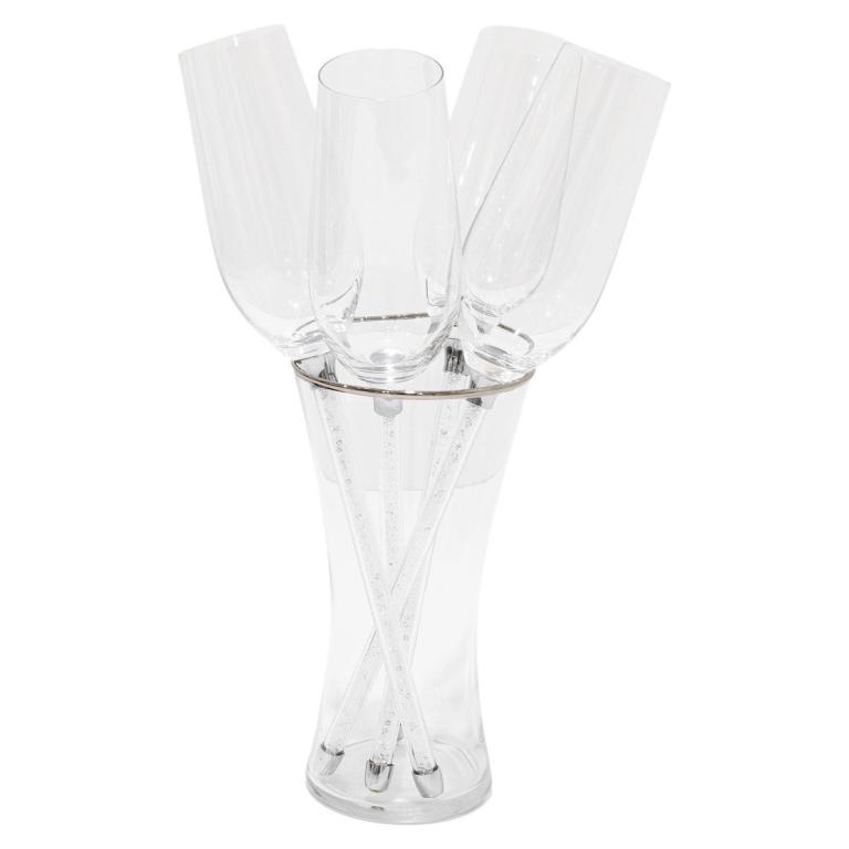 Five clear crystal flutes with rhinestone-filled stems arranged in a clear vase all resting on a silver ring base.