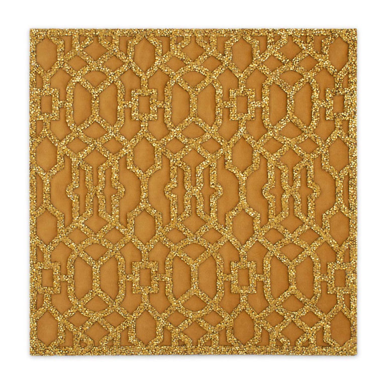 Gold lattice placemat with a laser-cut design and rhinestone embellishments on a smooth velvet backing.