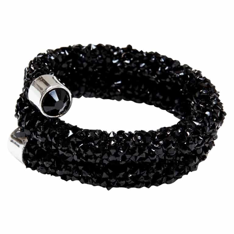 Black napkin rings made of flexible wire adorned with sparkling black stones and silver-tone embellishments.