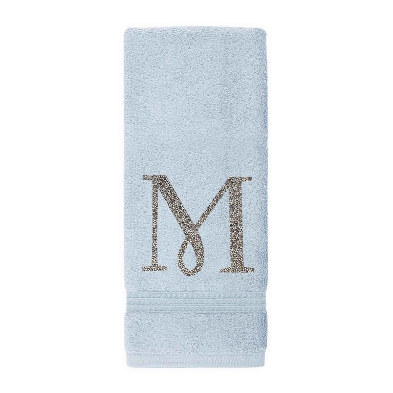 Aqua plush cotton terry hand towel with a sparkling rhinestone monogram "M" and a textured band at the bottom.