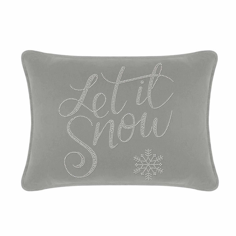 Silver velvet rectangular pillow with "Let it Snow" in rhinestones and a snowflake design on a smooth surface.