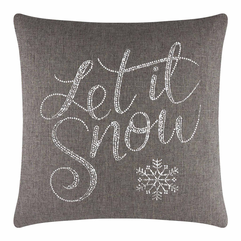 Square brown pillow with white glass rhinestones forming the text "Let it Snow" and a snowflake design on a textured fabric.
