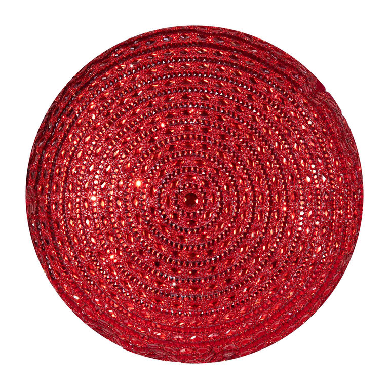 Round pillow in bright red plush velvet with a spiral pattern and rhinestone embellishments.