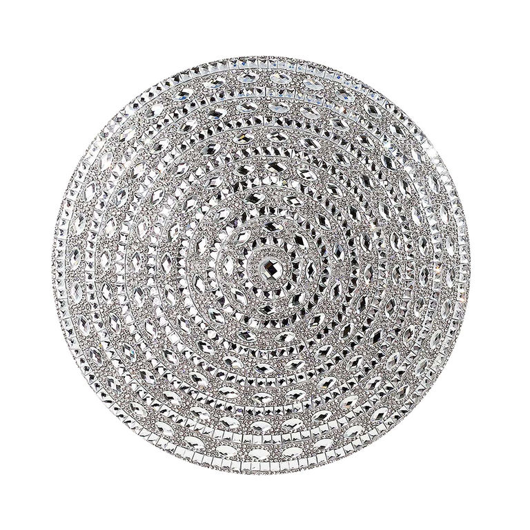 Round silver pillow with a plush velvet texture featuring a spiral design of rhinestones and mirrored embellishments.
