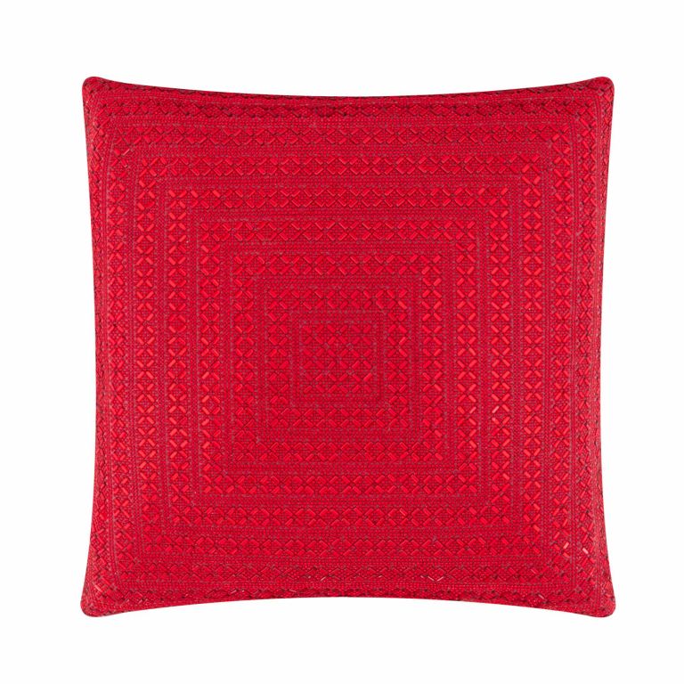 Red square pillow featuring intricate geometric patterns soft velvet texture and a plush appearance.