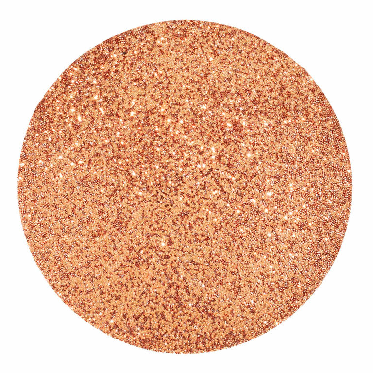 Round copper placemat with a textured surface embellished with vibrant rhinestones reflecting light and adding sparkle.