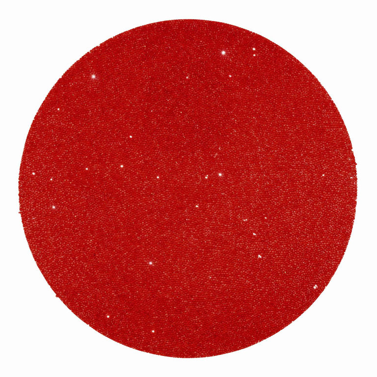 Red round placemat with a textured surface and vibrant rhinestone embellishments.