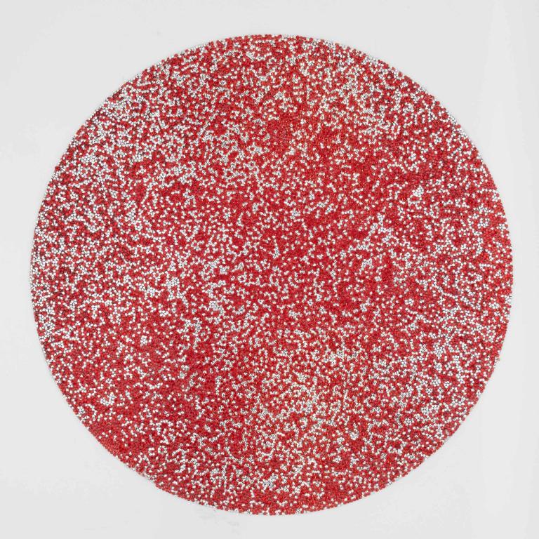 Round placemat featuring a vibrant red surface embellished with silver rhinestones textured and sparkly.