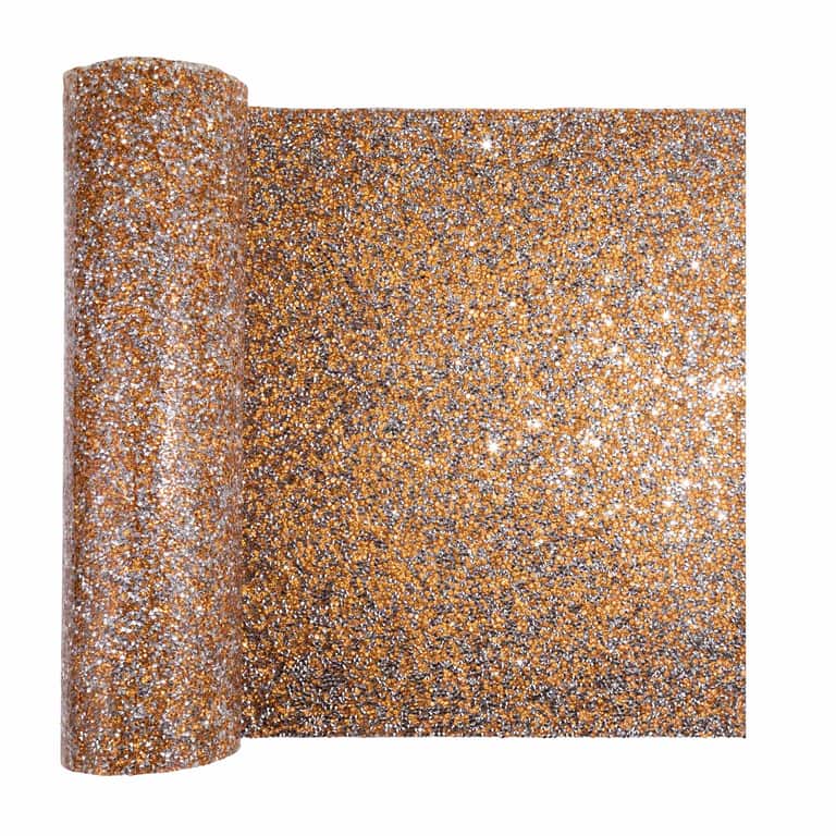 A shimmering table runner in topaz with a textured surface featuring sparkling rhinestones in gold silver and bronze hues.