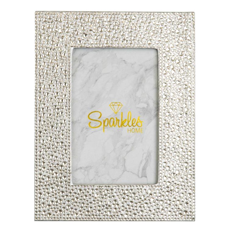 Silver picture frame with a textured surface adorned with glass rhinestones featuring a white marble background and yellow text.