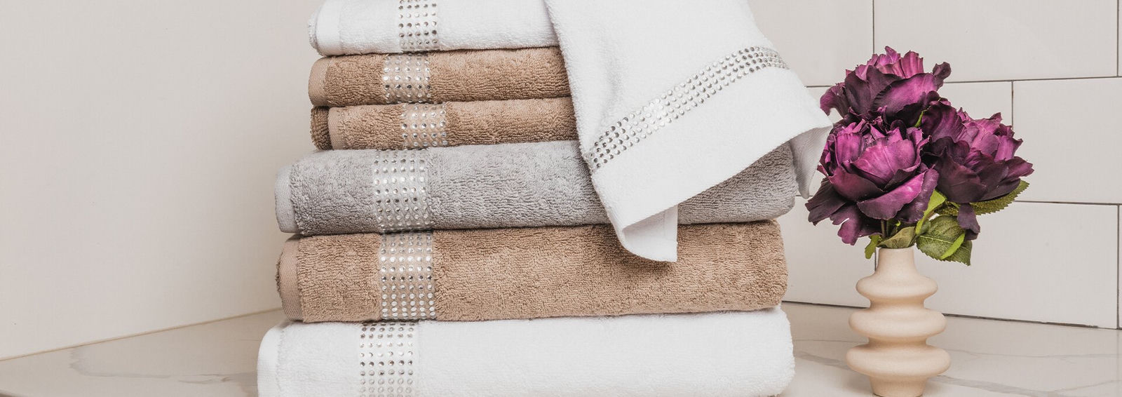 stacked&amp;&#x23;x20&#x3B;luxury&amp;&#x23;x20&#x3B;rhinestone-accented&amp;&#x23;x20&#x3B;bath&amp;&#x23;x20&#x3B;towels&amp;&#x23;x20&#x3B;in&amp;&#x23;x20&#x3B;neutral&amp;&#x23;x20&#x3B;tones&amp;&#x23;x20&#x3B;next&amp;&#x23;x20&#x3B;to&amp;&#x23;x20&#x3B;faux&amp;&#x23;x20&#x3B;purple&amp;&#x23;x20&#x3B;flowers&amp;&#x23;x20&#x3B;on&amp;&#x23;x20&#x3B;marble&amp;&#x23;x20&#x3B;countertop