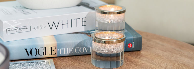 pair&amp;&#x23;x20&#x3B;of&amp;&#x23;x20&#x3B;rhinestone&amp;&#x23;x20&#x3B;tealight&amp;&#x23;x20&#x3B;holders&amp;&#x23;x20&#x3B;on&amp;&#x23;x20&#x3B;wood&amp;&#x23;x20&#x3B;table&amp;&#x23;x20&#x3B;with&amp;&#x23;x20&#x3B;white&amp;&#x23;x20&#x3B;decor&amp;&#x23;x20&#x3B;books&amp;&#x23;x20&#x3B;and&amp;&#x23;x20&#x3B;silver&amp;&#x23;x20&#x3B;tray