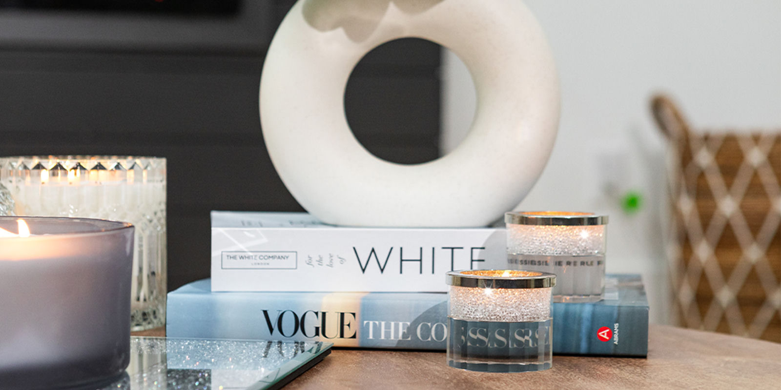 Candles,&amp;&#x23;x20&#x3B;stacked&amp;&#x23;x20&#x3B;books,&amp;&#x23;x20&#x3B;and&amp;&#x23;x20&#x3B;a&amp;&#x23;x20&#x3B;sculptural&amp;&#x23;x20&#x3B;vase&amp;&#x23;x20&#x3B;styled&amp;&#x23;x20&#x3B;on&amp;&#x23;x20&#x3B;a&amp;&#x23;x20&#x3B;mirrored&amp;&#x23;x20&#x3B;tray