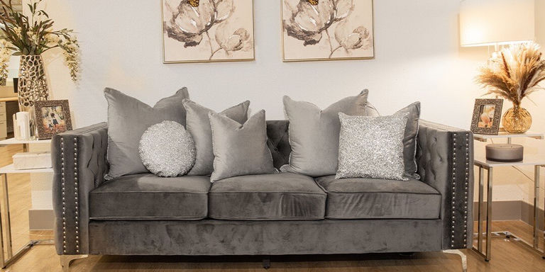 gray velvet sofa styled with rhinestone and velvet pillows in glam neutral living room