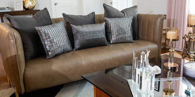 Black and silver rhinestone throw pillows styled on brown glam velvet couch