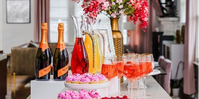 pink cupcakes and champagne displayed on glam rhinestone brunch buffet