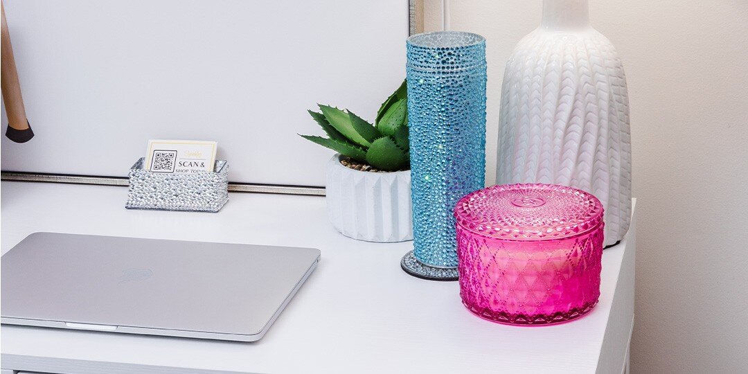 Close-up&amp;&#x23;x20&#x3B;of&amp;&#x23;x20&#x3B;white&amp;&#x23;x20&#x3B;desk&amp;&#x23;x20&#x3B;surface&amp;&#x23;x20&#x3B;with&amp;&#x23;x20&#x3B;laptop,&amp;&#x23;x20&#x3B;rhinestone&amp;&#x23;x20&#x3B;business&amp;&#x23;x20&#x3B;card&amp;&#x23;x20&#x3B;holder,&amp;&#x23;x20&#x3B;tall&amp;&#x23;x20&#x3B;blue&amp;&#x23;x20&#x3B;rhinestone&amp;&#x23;x20&#x3B;cylinder&amp;&#x23;x20&#x3B;vase,&amp;&#x23;x20&#x3B;pink&amp;&#x23;x20&#x3B;rhinestone&amp;&#x23;x20&#x3B;container,&amp;&#x23;x20&#x3B;white&amp;&#x23;x20&#x3B;ribbed&amp;&#x23;x20&#x3B;planter&amp;&#x23;x20&#x3B;with&amp;&#x23;x20&#x3B;succulent,&amp;&#x23;x20&#x3B;and&amp;&#x23;x20&#x3B;white&amp;&#x23;x20&#x3B;textured&amp;&#x23;x20&#x3B;vase&amp;&#x23;x20&#x3B;in&amp;&#x23;x20&#x3B;background.