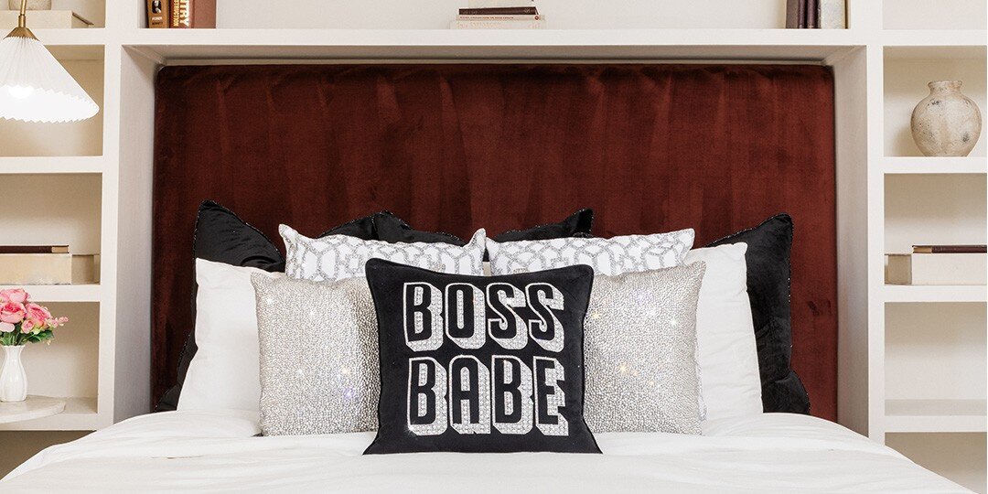 Bedroom&amp;&#x23;x20&#x3B;featuring&amp;&#x23;x20&#x3B;burgundy&amp;&#x23;x20&#x3B;velvet&amp;&#x23;x20&#x3B;tufted&amp;&#x23;x20&#x3B;headboard&amp;&#x23;x20&#x3B;built&amp;&#x23;x20&#x3B;into&amp;&#x23;x20&#x3B;white&amp;&#x23;x20&#x3B;shelving&amp;&#x23;x20&#x3B;unit,&amp;&#x23;x20&#x3B;styled&amp;&#x23;x20&#x3B;with&amp;&#x23;x20&#x3B;white&amp;&#x23;x20&#x3B;bedding,&amp;&#x23;x20&#x3B;sparkly&amp;&#x23;x20&#x3B;silver&amp;&#x23;x20&#x3B;throw&amp;&#x23;x20&#x3B;pillows,&amp;&#x23;x20&#x3B;black&amp;&#x23;x20&#x3B;