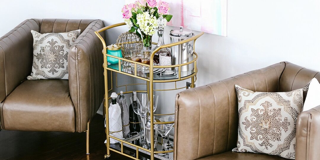 glam&amp;&#x23;x20&#x3B;bar&amp;&#x23;x20&#x3B;cart&amp;&#x23;x20&#x3B;with&amp;&#x23;x20&#x3B;gold&amp;&#x23;x20&#x3B;frame,&amp;&#x23;x20&#x3B;fresh&amp;&#x23;x20&#x3B;flowers,&amp;&#x23;x20&#x3B;and&amp;&#x23;x20&#x3B;rhinestone&amp;&#x23;x20&#x3B;pillows&amp;&#x23;x20&#x3B;in&amp;&#x23;x20&#x3B;leather&amp;&#x23;x20&#x3B;chairs