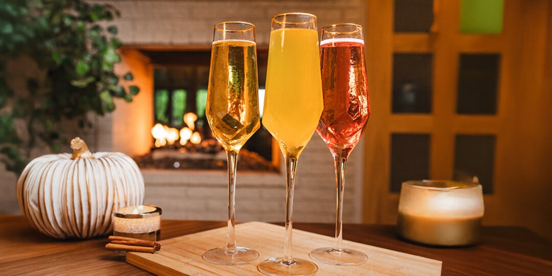 Trio&amp;&#x23;x20&#x3B;of&amp;&#x23;x20&#x3B;fall&amp;&#x23;x20&#x3B;mimosa&amp;&#x23;x20&#x3B;cocktails&amp;&#x23;x20&#x3B;in&amp;&#x23;x20&#x3B;Prism&amp;&#x23;x20&#x3B;flutes&amp;&#x23;x20&#x3B;with&amp;&#x23;x20&#x3B;autumn&amp;&#x23;x20&#x3B;decor&amp;&#x23;x20&#x3B;in&amp;&#x23;x20&#x3B;background