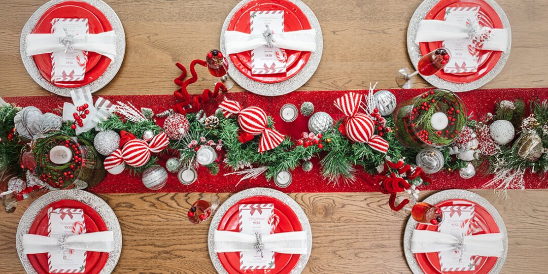 overhead&amp;&#x23;x20&#x3B;view&amp;&#x23;x20&#x3B;of&amp;&#x23;x20&#x3B;holiday&amp;&#x23;x20&#x3B;table&amp;&#x23;x20&#x3B;set&amp;&#x23;x20&#x3B;with&amp;&#x23;x20&#x3B;red&amp;&#x23;x20&#x3B;plates,&amp;&#x23;x20&#x3B;rhinestone&amp;&#x23;x20&#x3B;chargers,&amp;&#x23;x20&#x3B;and&amp;&#x23;x20&#x3B;peppermint&amp;&#x23;x20&#x3B;garland