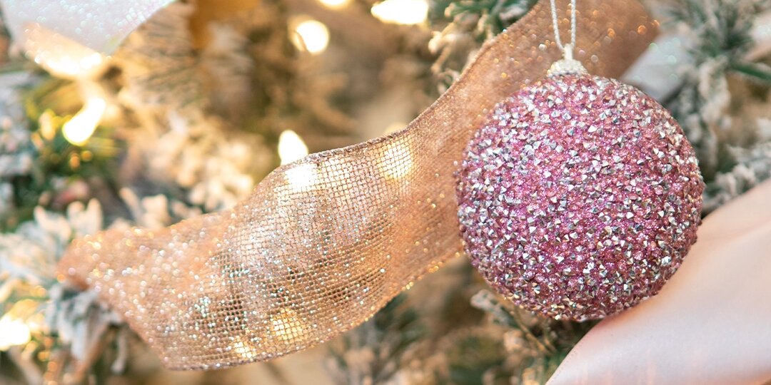 close-up&amp;&#x23;x20&#x3B;of&amp;&#x23;x20&#x3B;pink&amp;&#x23;x20&#x3B;rhinestone&amp;&#x23;x20&#x3B;Christmas&amp;&#x23;x20&#x3B;ornament&amp;&#x23;x20&#x3B;on&amp;&#x23;x20&#x3B;lit&amp;&#x23;x20&#x3B;and&amp;&#x23;x20&#x3B;frosted&amp;&#x23;x20&#x3B;tree&amp;&#x23;x20&#x3B;with&amp;&#x23;x20&#x3B;gold&amp;&#x23;x20&#x3B;ribbon