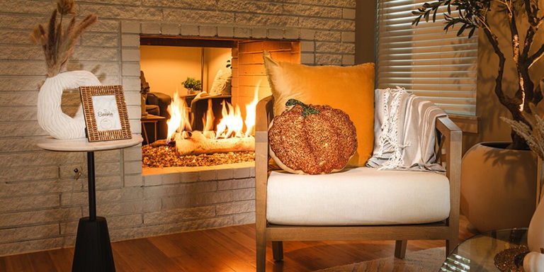 modern fall glam living room with pumpkin accent pillow, velvet throw, and rhinestone details