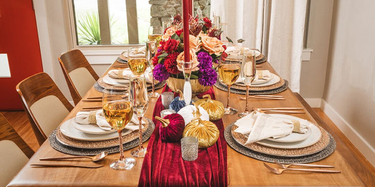Elegant harvest table with rose gold flatware, velvet pumpkins, and crystal stemware