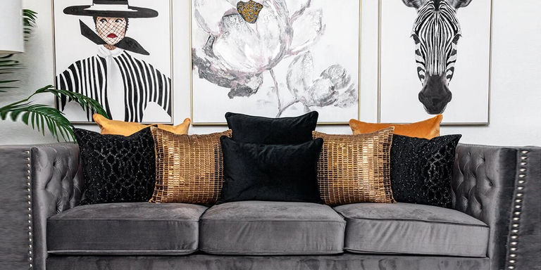 glamorous neutral living room with gold accents and tufted sofa