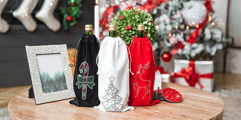 Holiday rhinestone wine bags with crystal motifs and Christmas tree