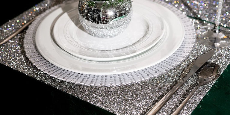 silver rhinestone charger with layered white dinnerware and mirrored ornament centerpiece