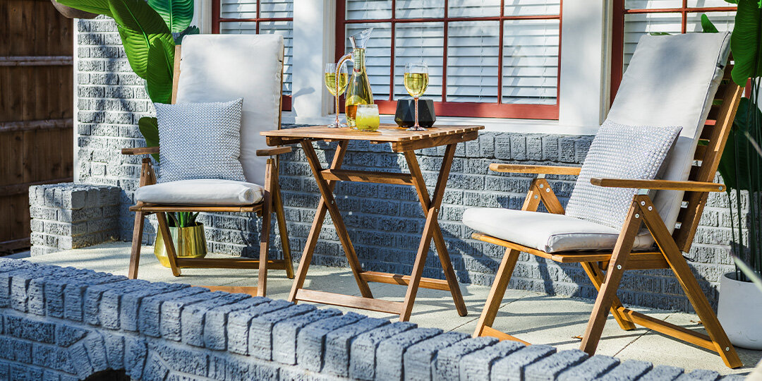 Modern&amp;&#x23;x20&#x3B;outdoor&amp;&#x23;x20&#x3B;patio&amp;&#x23;x20&#x3B;with&amp;&#x23;x20&#x3B;white&amp;&#x23;x20&#x3B;cushioned&amp;&#x23;x20&#x3B;wooden&amp;&#x23;x20&#x3B;lounge&amp;&#x23;x20&#x3B;chairs,&amp;&#x23;x20&#x3B;teak&amp;&#x23;x20&#x3B;folding&amp;&#x23;x20&#x3B;table&amp;&#x23;x20&#x3B;with&amp;&#x23;x20&#x3B;champagne&amp;&#x23;x20&#x3B;glasses&amp;&#x23;x20&#x3B;and&amp;&#x23;x20&#x3B;tropical&amp;&#x23;x20&#x3B;plants